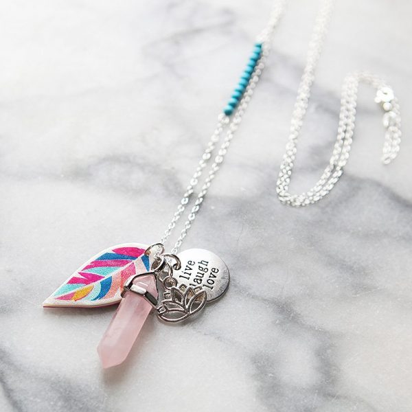 A fun boho style gemstone necklace with Next Romance signature feather, affirmation charm, pendulum gemstone and matching gem detail on a classic long chain.